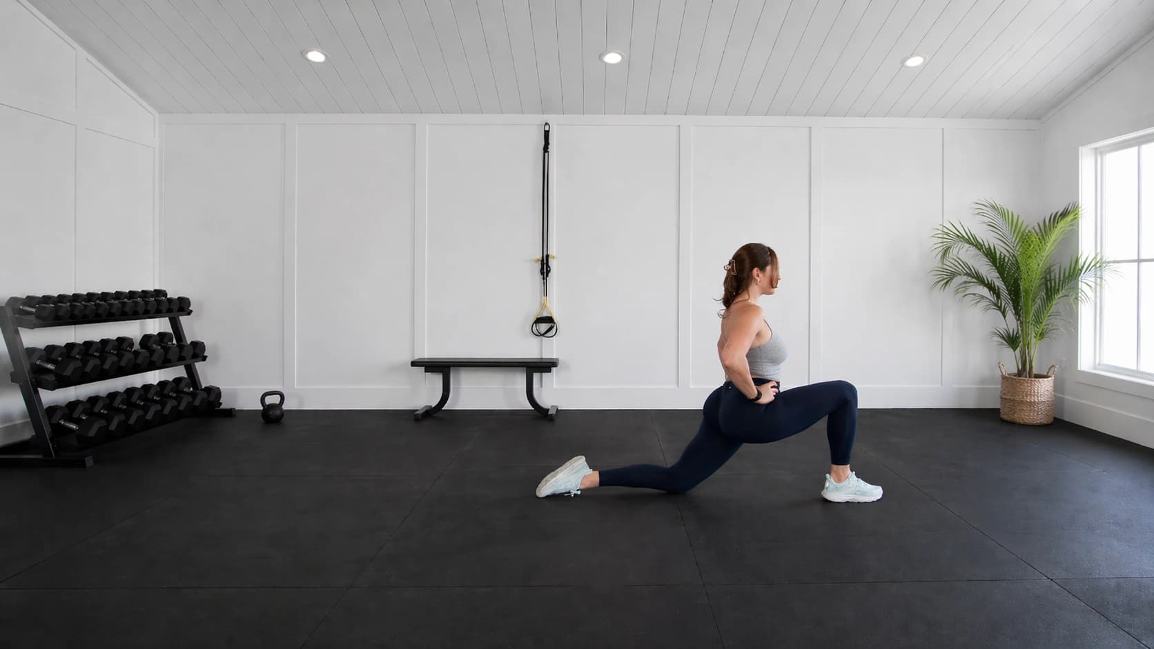 Nicolette holding a deep lunge in her private training studio.