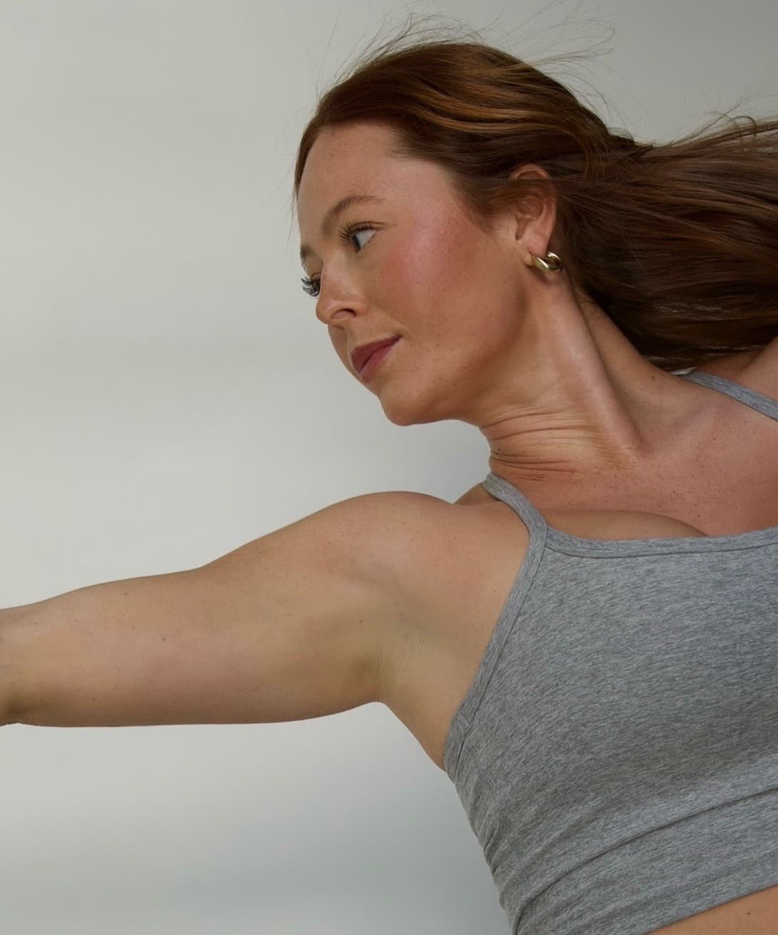 Nicolette holding a side plank position in the studio.